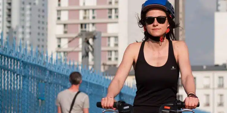 a woman riding a bike with a helmet on