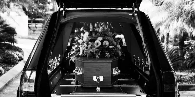 grayscale photo of car with flowers